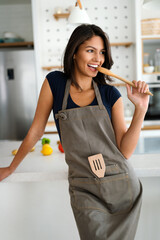 Beautiful young woman cooking in the kitchen. Healthy, organic, food concept