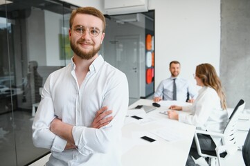 Portrait of a leader with business team behind.