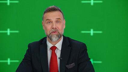 Newsroom TV Studio Live News Program with Green Screen Background: Male Presenter Reporting, Talking. Television Cable Channel Anchor. Network Broadcast Mock-up with Tracking Markers - obrazy, fototapety, plakaty