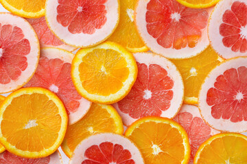 Round slices of citrus fruits top view. Citrus fruits orange and grapefruit background.