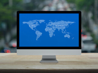 Global business words world map on desktop modern computer monitor screen on wooden table over blur of rush hour with cars and road in city, Global business online concept, Elements of this image furn