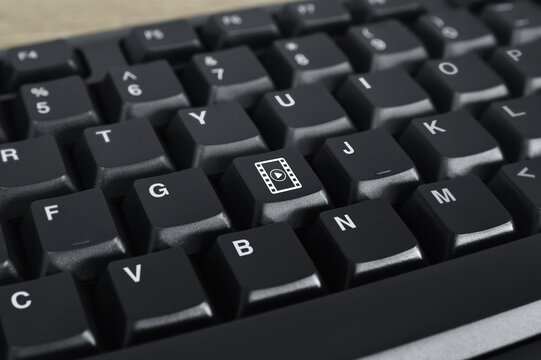 Play button with movie flat icon on black computer keyboard button, Business cinema online concept