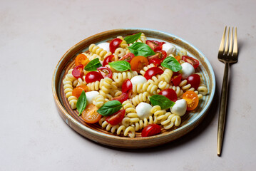 Fusilli pasta with mozzarella, tomatoes and basil. Italian food. Healthy eating. Vegetarian food.