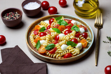 Fusilli pasta with mozzarella, tomatoes and basil. Italian food. Healthy eating. Vegetarian food.