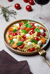 Fusilli pasta with mozzarella, tomatoes and basil. Italian food. Healthy eating. Vegetarian food.