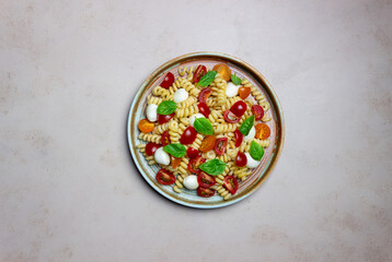 Fusilli pasta with mozzarella, tomatoes and basil. Italian food. Healthy eating. Vegetarian food.