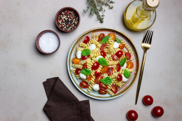 Fusilli pasta with mozzarella, tomatoes and basil. Italian food. Healthy eating. Vegetarian food.