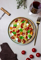 Fusilli pasta with mozzarella, tomatoes and basil. Italian food. Healthy eating. Vegetarian food.