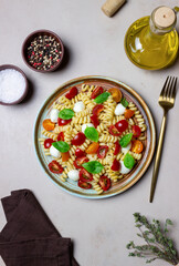 Fusilli pasta with mozzarella, tomatoes and basil. Italian food. Healthy eating. Vegetarian food.
