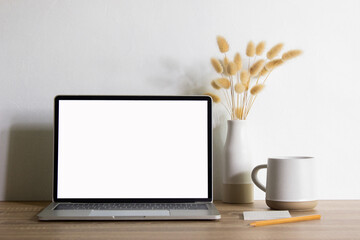 Mock up Computer with natural flower and coffee mug with nature light.