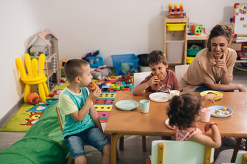 kids having breakfast in kindergarden