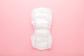 Opened white big size sanitary towel on pink table background. Pastel color. Closeup. Hygiene product for urinary incontinence or after childbirth. Top down view. © fotoduets