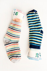 Bunch of Euro's. Close-up. Saving money in sock. Euro banknotes out from it. Keeping savings at home. Finance, savings, investing. Money management at home. Financial business concept.