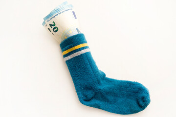 Bunch of Euro's. Close-up. Saving money in sock. Euro banknotes out from it. Keeping savings at home. Finance, savings, investing. Money management at home. Financial business concept.