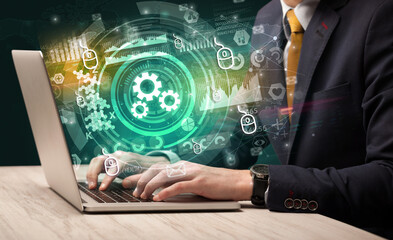 Business hand typing on a modern laptop