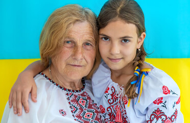 Ukrainian grandmother and granddaughter in vyshyvanka. selective focus.