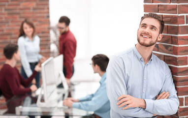 Businessman with colleagues in the background in office
