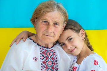 Ukrainian grandmother and granddaughter in vyshyvanka. selective focus.
