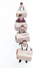 Young movers holding boxes standing in a row, isolated on white