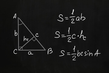Basic triangle area formulas written on chalkboard