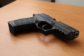Semi-automatic pistol on wooden table. Standard handgun - obrazy, fototapety, plakaty