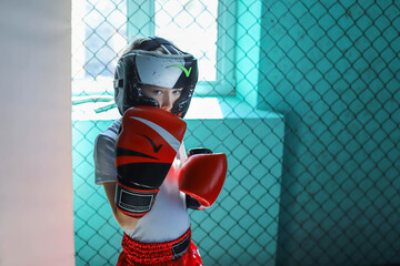 The boy is preparing for a boxing fight, Thai boxing.