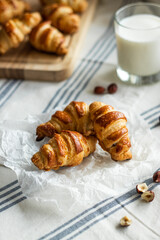 Home made mini croissants with hazelnuts and milk in a glass