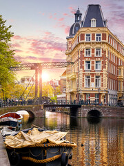 Amsterdam, Netherlands. Panoramic view of autumn Dutch city. Famous channel of Amstel river. Evening cityscape. Colorful sunset scene of famous travel destination in Europe. Romantic traveling place. - 510780292