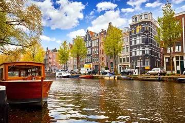 Gordijnen Channel in Amsterdam Netherlands houses river Amstel landmark old european city spring landscape. © Yasonya