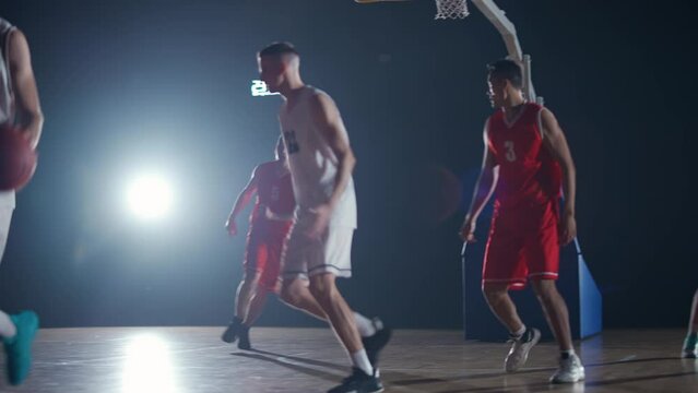 International basketball game, the confrontation between two teams, sporty lifestyle, mens active game at night time, cinematic light.