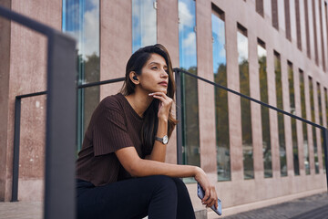 Fototapeta premium Young cute businesswoman sitting and contemplating