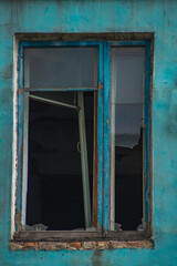 A broken window in an old abandoned house