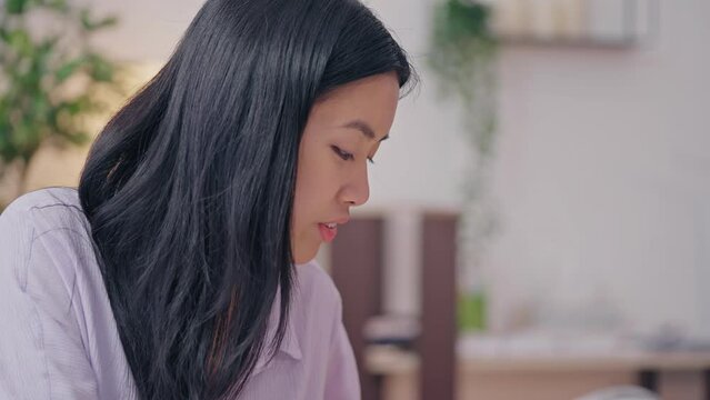 Young beauty blogger applying eyeshadows on smartphone camera cosmetics review
