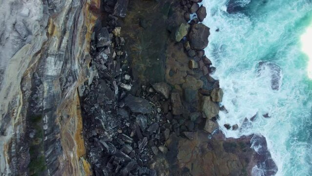 Drone footage of the green coastal cliffs and seascape, Wedding Cake Rock, Australia.