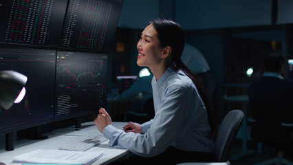 Happy financial analytics looking at screen with chart and smile