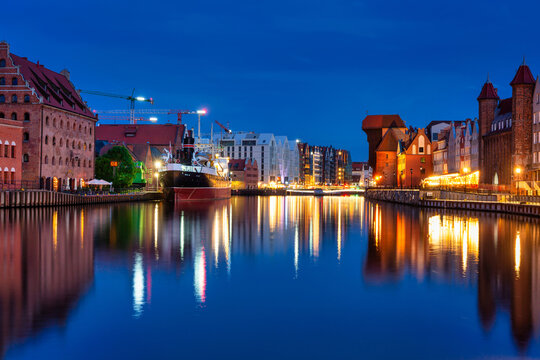 Beautiful Gdansk city reflected in the Motlawa River at dusk. Poland