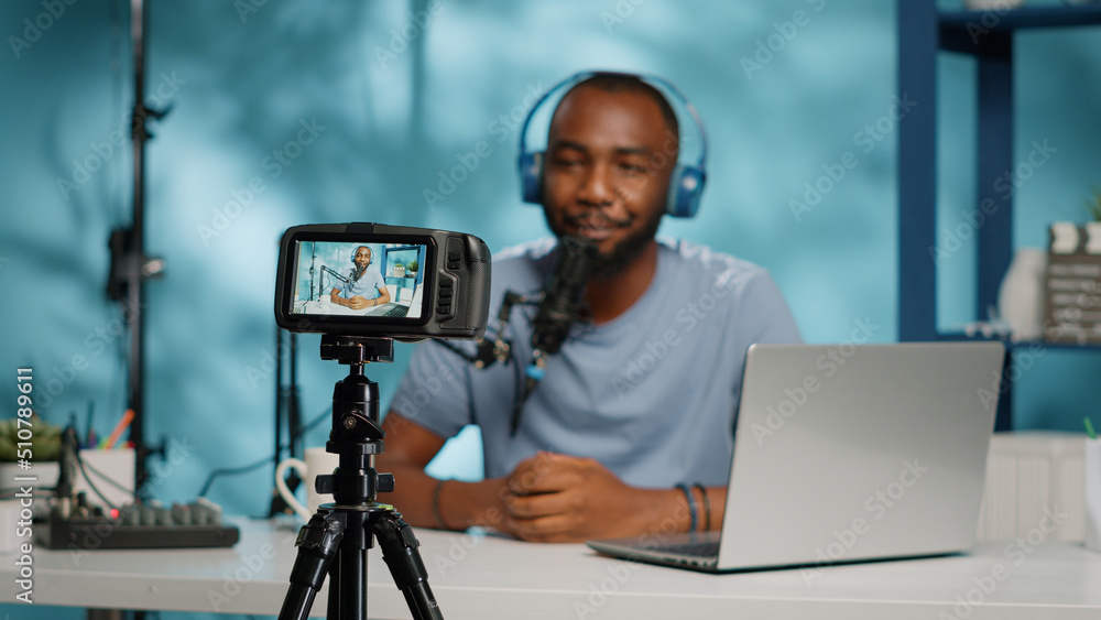 Poster close up of content creator recording video on camera using modern equipment and tripod. vlogger wit