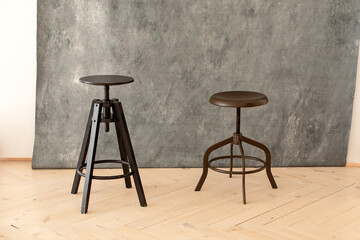 black minimalist metal chairs against grey background. Concept modern interior and design furniture...