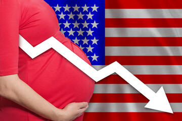 American pregnant woman on USA flag background. Falling fertility rate in America.