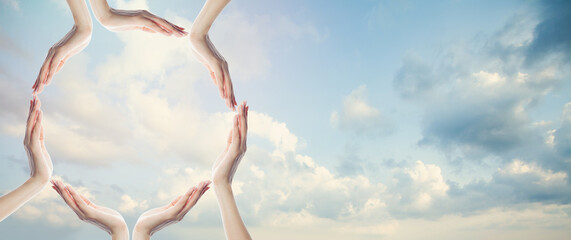 Obraz premium Sky clouds background with many human hands frame