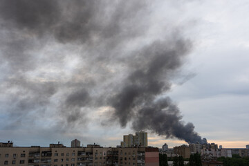 Fototapeta na wymiar Thick smoke in the clouds, fire in city.