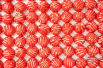 Red round tasty gummy candies as a background.