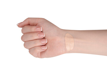 Swatch of foundation on a woman hand isolated on white background.