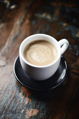 Cup of coffee on wooden background. Close up.