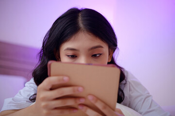 College student reading captivating book or article on tablet computer