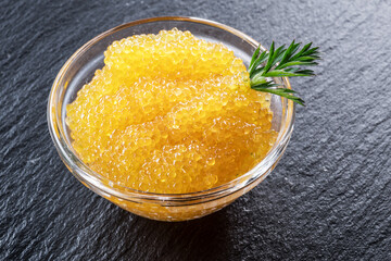 Pike caviar or roe in the bowl on wooden background.