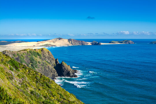 Breathtaking view over Te Werahi Beach and Cape Maria Van Diemen from a high vantage point in Cape Reinga on a bright winter day. North Island, New Zealand