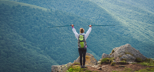 Naklejka premium Young woman n the top of the mountains