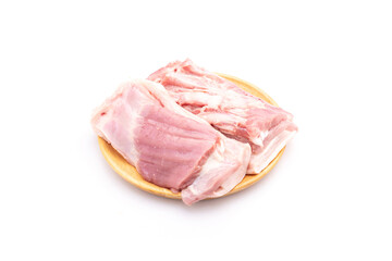 Raw streaky pork on wooden dish isolated on white background. Food and healthcare concept
