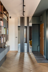 Creative and modern vintage living room interior design with yellow sofa and turquoisre furniture,  bookcase and chest of drawers. Herringbone parquet.curtain in windows. Template. Home decor.